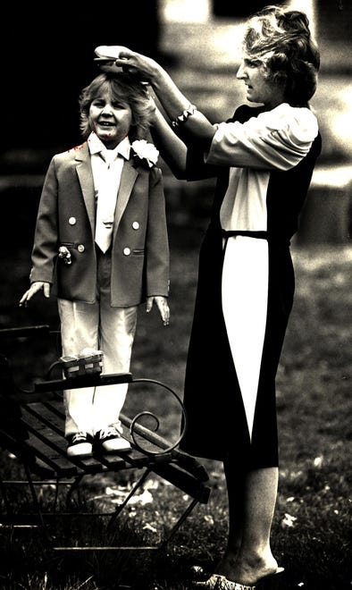 Patty Fenland puts the finishing touches on 3-year-old Jeff's Easter suit in this 1988 photo in New Castle.