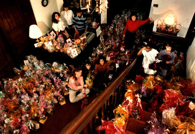 Members of the Catholic Youth Organization sit with the Easter baskets they prepared for the needy in 1989.