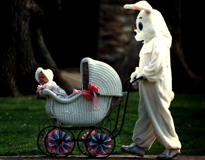 Easter Bunny (Kay Nardone) give 8-month old Elissa Cashman a ride in an antique carriage on the Green in New Castle in 1990.