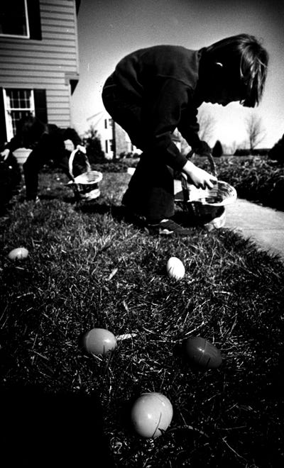 Michael Sylvester picks up eggs at his home in 1993.