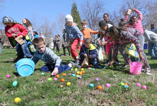 Kids scramble to collect eggs during an Easter egg hunt put on by City Church at Tilton Park in Wilmington in 2023.
