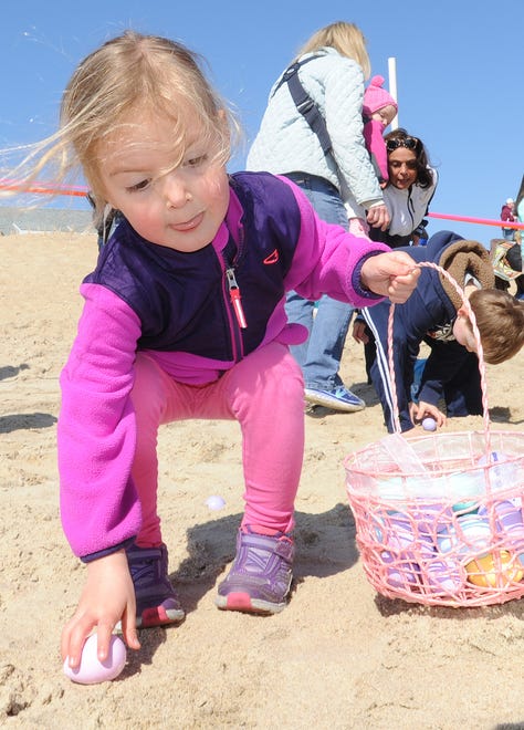 Kirby Tokarczyk, 4, of Wilmington, snags an egg from the sand at Dewey Beach's annual Easter Egg Scoop in 2016.