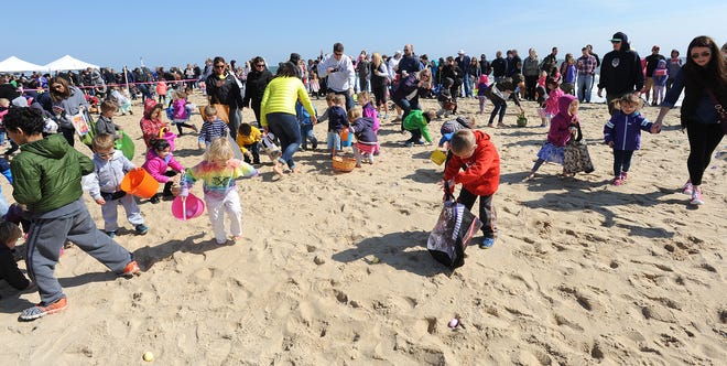 Children search for buried treasure in the form of Easter eggs on Dewey Beach during the annual Easter Egg Scoop in 2016.