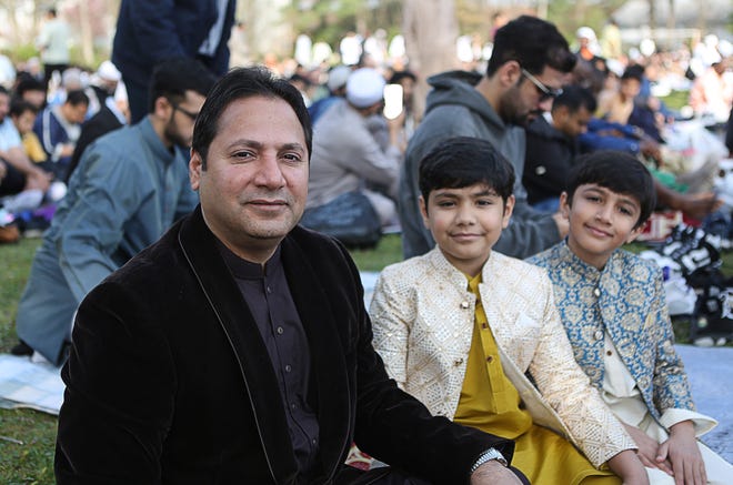 Malik Ali (left) is joined with his two sons, Eesa (center) and Malik (right) to celebrate Eid al-Fitr in Ogletown on Wednesday April 10, 2024.