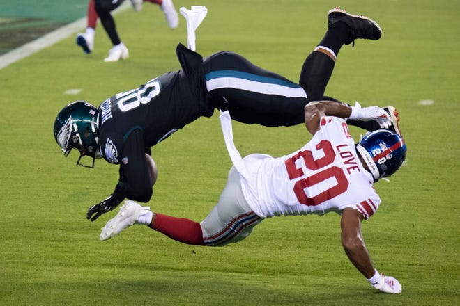 The Eagles' Richard Rodgers (85) is tackled by Giants' Julian Love (20) in last month's game in Philadelphia.