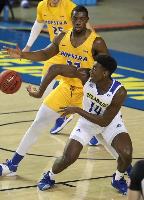 Delaware's Ebby Asamoah throws a pass away from Hofstra's Isaac Kante in the first half of the Blue Hens' 74-56 win at the Bob Carpenter Center Friday, Jan. 15, 2021.