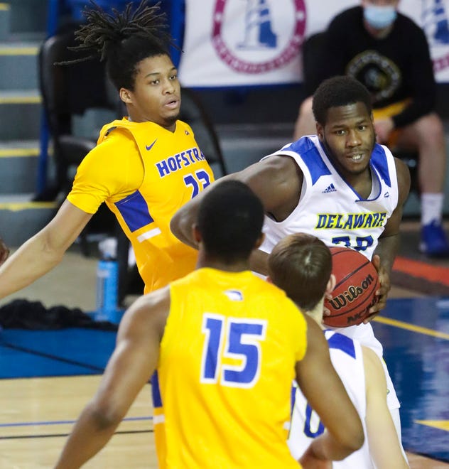 Hofstra's Kvonn Cramer (left) can't get to a rebound against Delaware's Anthony Ochefu in the second half of the Blue Hens' 74-56 win at the Bob Carpenter Center Friday, Jan. 15, 2021.