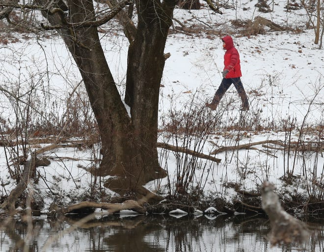 A person walks through snowy Brandywine Park in Wilmington Thursday afternoon, Feb. 18, 2021.