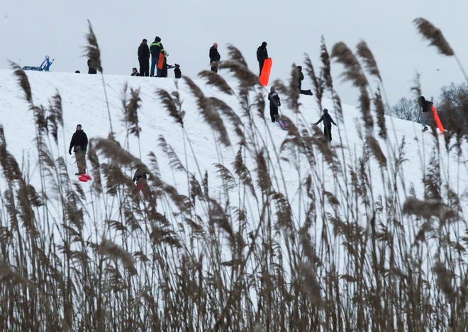People take advantage of Thursday's snowstorm and the sledding hill at Glasgow Park, Feb. 18, 2021.