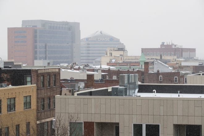 The Chase Building is seen as snow lightly falls over downtown Wilmington Thursday, Feb. 18, 2021.