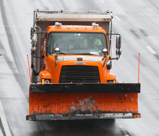 A DelDOT truck carries its plow up but keeps treating I-95 in Wilmington late afternoon Thursday, Feb. 18, 2021.